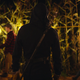 A mysterious killer stands in a corn maze with their back to the camera in There's Someone Inside Your House.